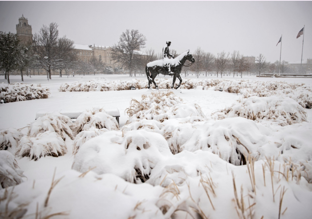 Sculpture of man on horse in the snow