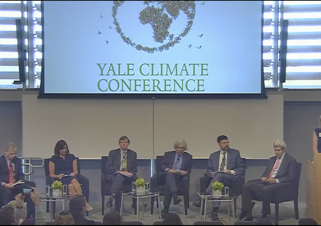 Photo of panelists, Including Ernest Moniz an John Kerry, at the Yale Climate Conference in 2017