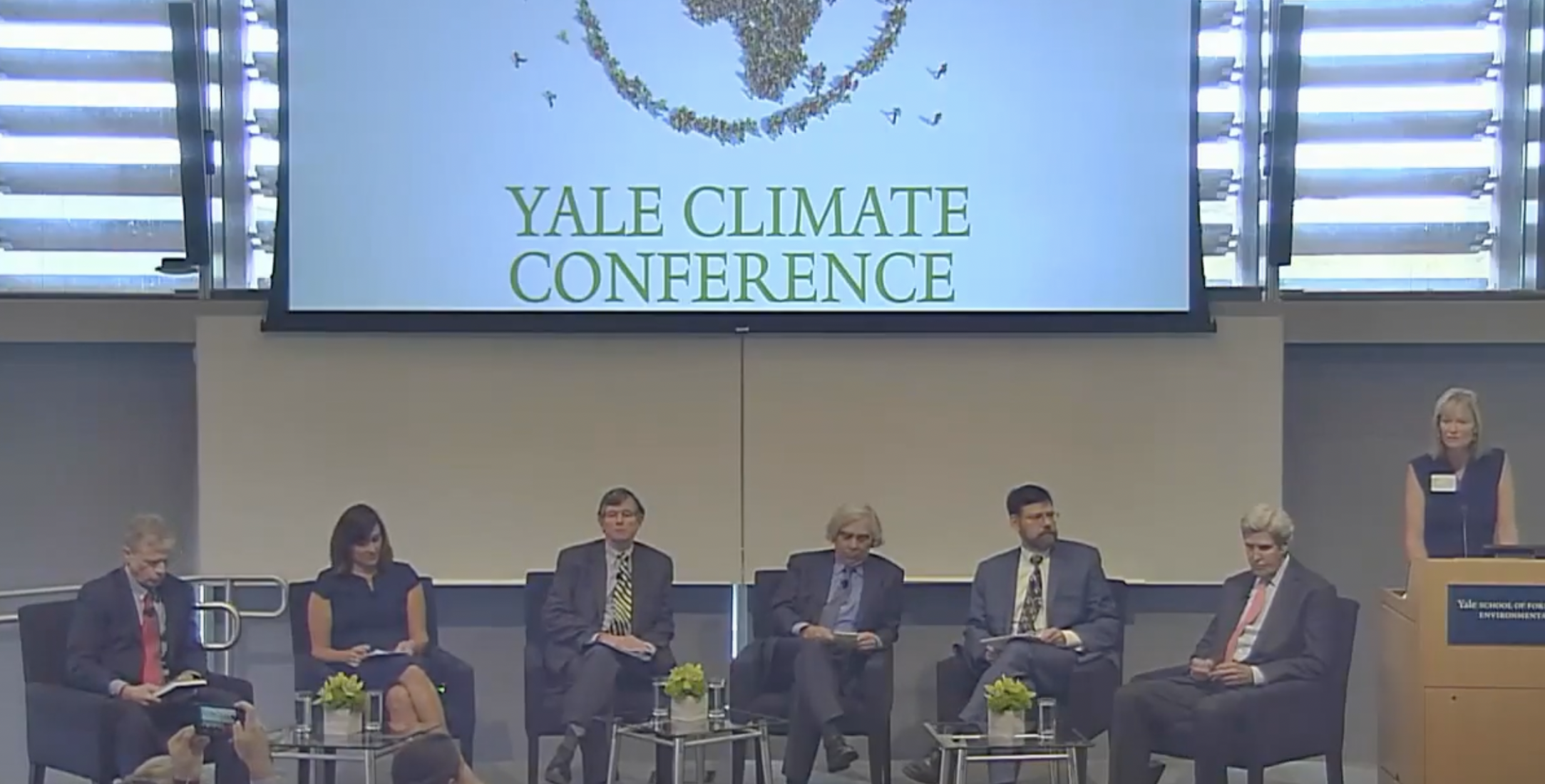 Photo of panelists, Including Ernest Moniz an John Kerry, at the Yale Climate Conference in 2017