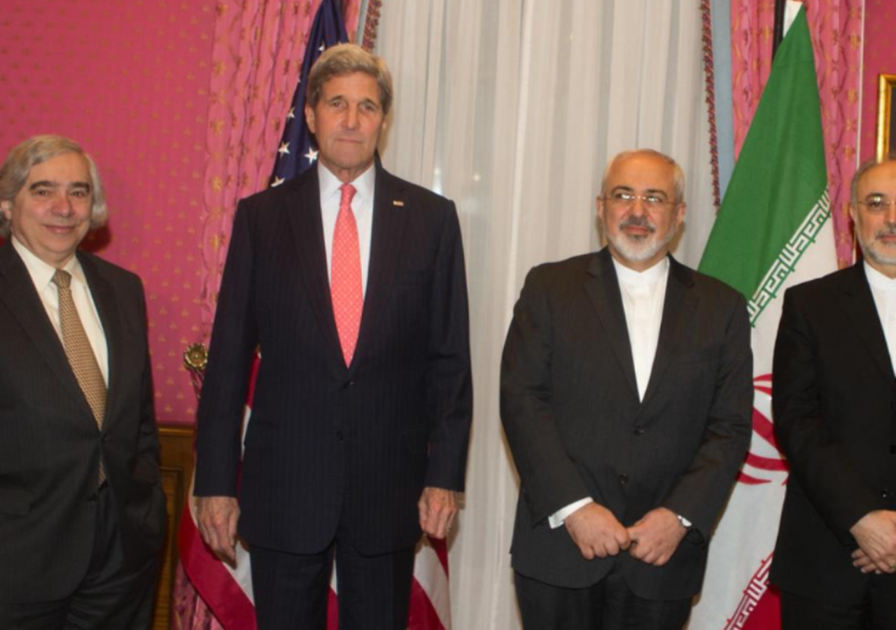Photo of former energy secretary and EFI Foundation CEO Ernest Moniz negotiating the Iran nuclear deal with former Secretary of State John Kerry and two Iranian officials.